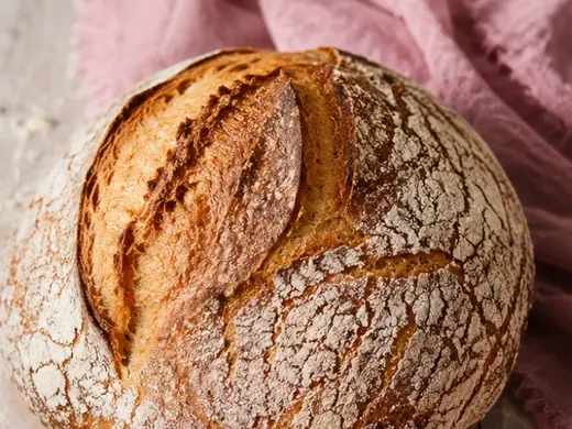 Round sourdough boule with a scored crust